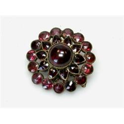 An early 19th century flowerhead brooch set with garnets, 30mm diameter  £100-150...