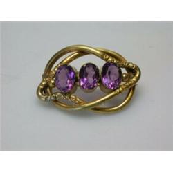 A 19th century knot brooch set with three amethyst coloured stones   £30-50...