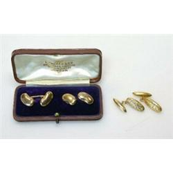 A pair of 9ct gold cufflinks of torpedo shape, engraved and another cased pair of cufflinks of bean.