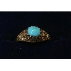 A ring set with an oval turquoise stone set above pierced scrolled shoulders   £50-70...