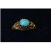 Image 1 : A ring set with an oval turquoise stone set above pierced scrolled shoulders   £50-70...