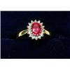 Image 1 : An 18ct gold ring set with a synthetic ruby within a diamond surround  £170-200...