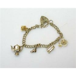 A 9ct gold wire curblink bracelet with padlock clasp suspended with five novelty charms  £70-100...