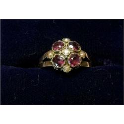 A dress ring set with a garnet and pearl cluster £100-200...