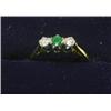 Image 1 : An 18ct gold three stone ring set with emerald and diamonds   £70-100...