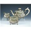 Image 1 : A silver three piece teaset, maker A.M. & Co, Sheffield 1928, comprising: a teapot of compressed re.