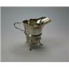 Image 1 : A silver creamer in the mid 18th century style by T Hill, Birmingham 1975, of helmet shape with cut.