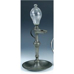 A 19th century French pewter and glass oil lamp, the glass reservoir bulb screwing into the boat pr.