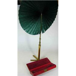 An early 19th century cased face screen, the red scrim case containing green pleated silkscreen, br.