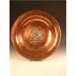 Hugh Wallis, an early 20th century copper bowl, the centre hammered and silvered with a galleon, th.