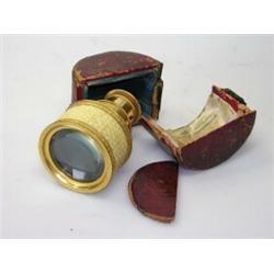 An early 19th century French opera telescope of six gilt metal draws and a diamond diaper turned iv.
