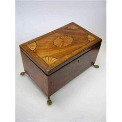 A George III mahogany tea caddy, the rectangular lid marquetried with oval paterae and quarter span.