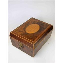 An early 19th century rosewood workbox, the lid of the sarcophagus shape with central satinwood ova.