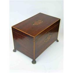 A George III mahogany tea caddy, the rectangular lid and front inlaid with conch shells central to..