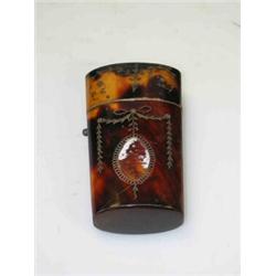 A George III tortoiseshell etui, silver piqué with garrya swags and flowers over oval escutcheons,..