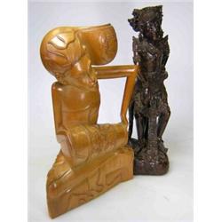 A Balinese wood carving of a man in highly decorated traditional dress dancing, 27cm high and a lat.