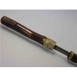 A late Victorian swordstick, the knobbly cane dividing about a gilt metal Royal coat of arms appliq.