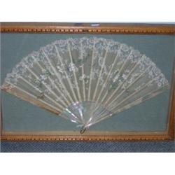 A framed 19th century French fan, the muslin leaf trimmed with lace and painted with marguerites an.