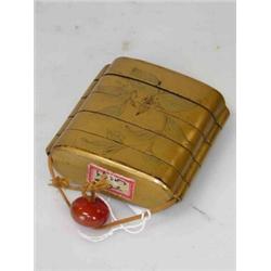 A 19th century Japanese gold lacquered inro, the four cases decorated with a magnolia frond on one..