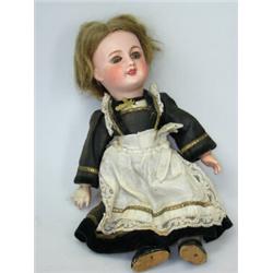 An early 20th century SFBJ 'Unis' bisque headed doll, numbered 301, the blonde head with sleepy eyes
