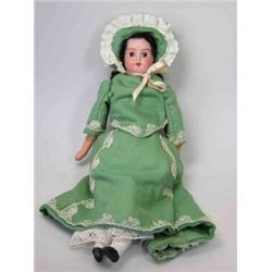 An early 20th century Cuno and Otto Dressel bisque headed shoulder doll, numbered 21/0, the dark ha.