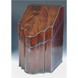 A George III mahogany knife box, the hinged sloping lid with shaped serpentine front, the corners an