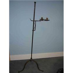 A 19th century iron adjustable candelabra, the two nozzles cantilevered from the bracket adjustable.