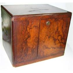 An early Victorian rosewood cigar humidor, the walnut veneered doors to the front closing on Bramah.