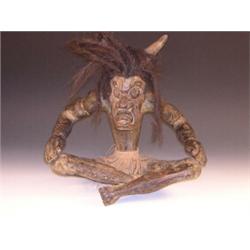 A 20th century ethnic wood carving of a shaman, possibly Oceanic, cow horns amongst his dreadlocks..