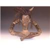 A 20th century ethnic wood carving of a shaman, possibly Oceanic, cow horns amongst his dreadlocks..