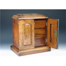 A 19th century walnut collector's cabinet, the doors applied with rectangular panels rounded at the.