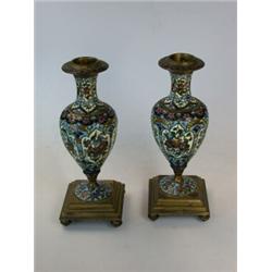 A pair of late 19th century French champleve enamel candlesticks, the baluster shapes decorated wit.