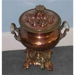 An early 19th century copper tea urn, the gadrooned lid with rosette finial, the thistle shaped bod.