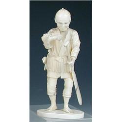 An early 20th century Japanese ivory and shark's tooth figure of a man standing holding a paddle in.