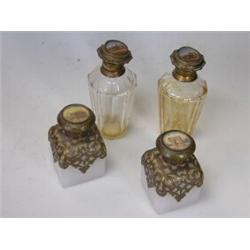 Two pairs of 19th century French scent bottles, the gilt brass hinged lids bearing depictions of Pa.