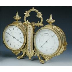 A Victorian combination desk timepiece and barometer, the leaf-cast gilt brass twin-drum case with..