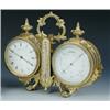Image 1 : A Victorian combination desk timepiece and barometer, the leaf-cast gilt brass twin-drum case with..