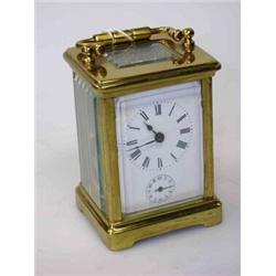 A French small brass carriage clock with alarm, with rectangular enamel dial and bell striking move.