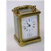 Image 1 : A French small brass carriage clock with alarm, with rectangular enamel dial and bell striking move.