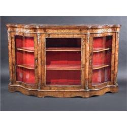 A Victorian figured walnut credenza, the moulded shaped top above a marquetry inlaid and ormolu mou.