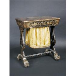 A 19th century Chinese export lacquered work table, the rounded rectangular rising top enclosing a..