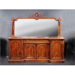 A Victorian mahogany inverted breakfront mirror back sideboard, the upper section with scroll carve.