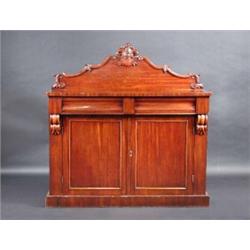 A Victorian mahogany chiffonier, the scroll carved solid back above a rectangular top, two frieze dr