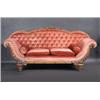 Image 1 : A Victorian oak framed scroll end settee, the foliate carved arched top rail above a padded button b