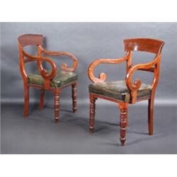 A set of six early Victorian mahogany dining chairs including two with arms, each with broad top rai