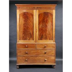 A Victorian mahogany linen press, the upper section with moulded cornice above a pair of arch panel.