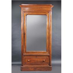 A Victorian mahogany wardrobe, the moulded cornice above a mirror inset door enclosing hanging spac.