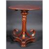 Image 1 : A mahogany tripod table, the circular top with carved edge supported on a scrolling column, standin.