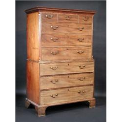 A George III mahogany chest on chest, the upper section with moulded dentil cornice above three sho.