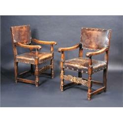 A set of eight oak dining chairs including two with arms, each with leather covered back and seat,..